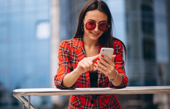 Woman playing mobile game to earn brand rewards