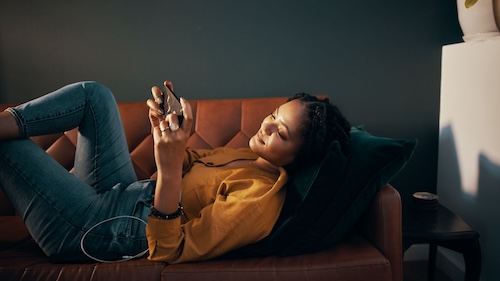 Woman playing mobile game to earn reward at a restaurant